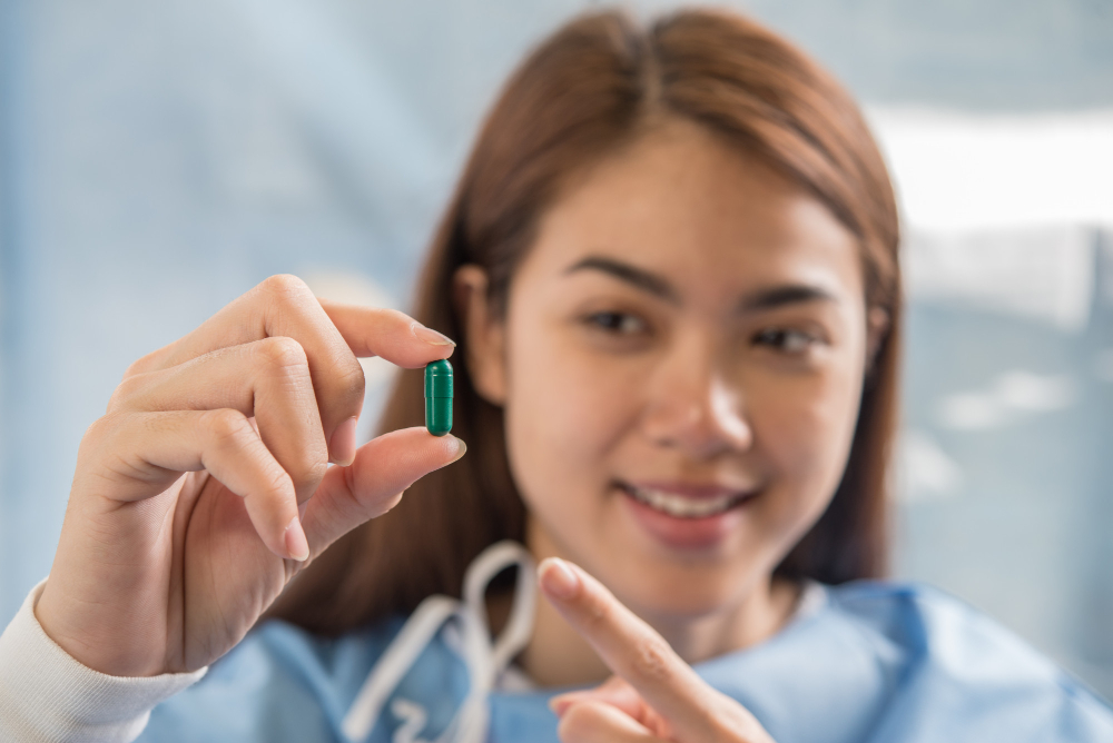 Woman hand holding a pills take medicine according to the doctor's order