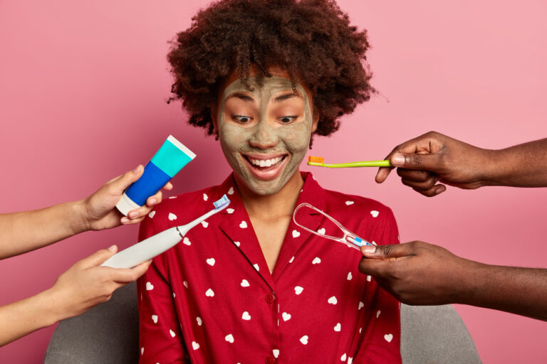 Dark skinned woman gets dental treatment, cares about teeth, wears red pajama