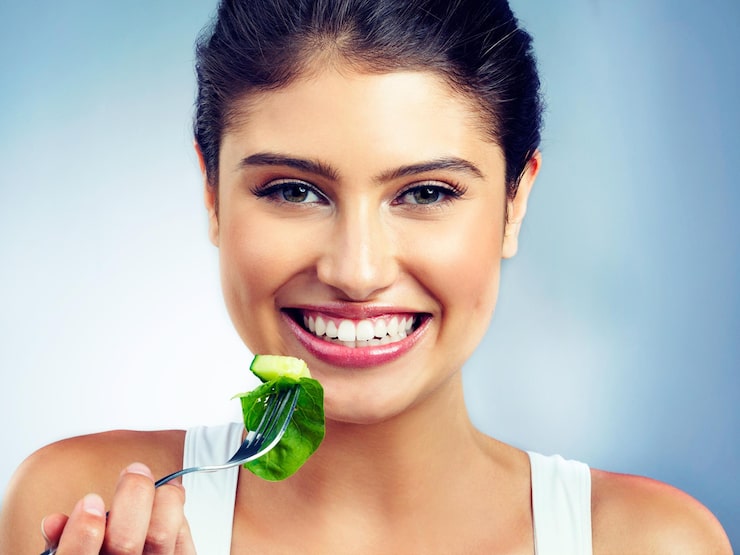 Woman portrait and happy salad and vegetable for health and nutritionist in isolated blue background vegan face and wellness diet with female model in studio and organic food for oral care
